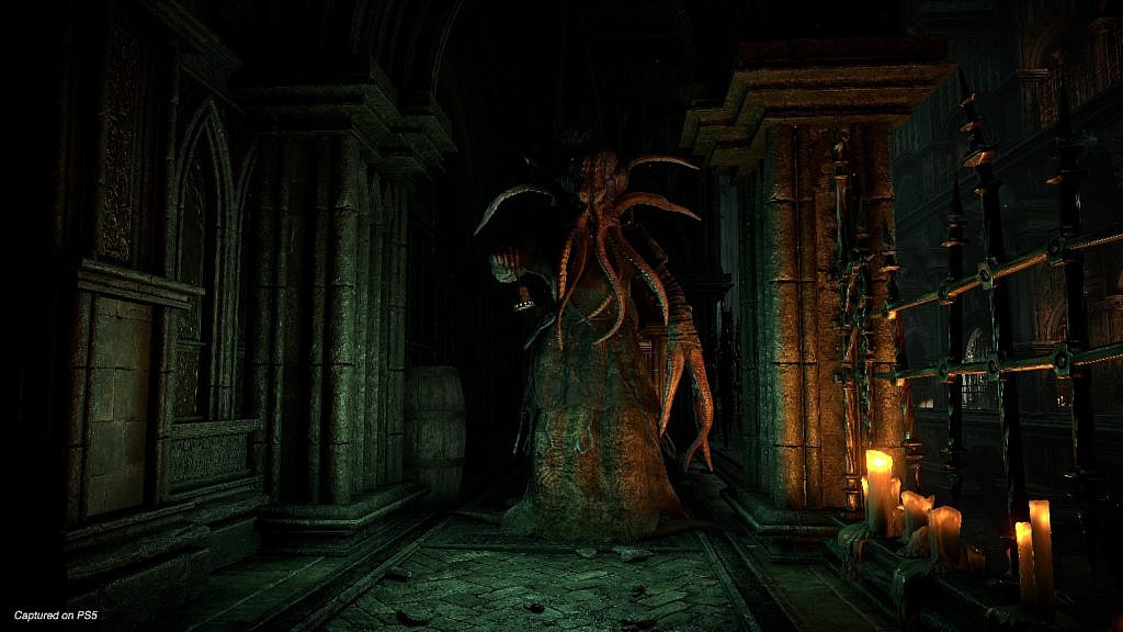An enemy with octopus head standing in the dark and narrow stony passage