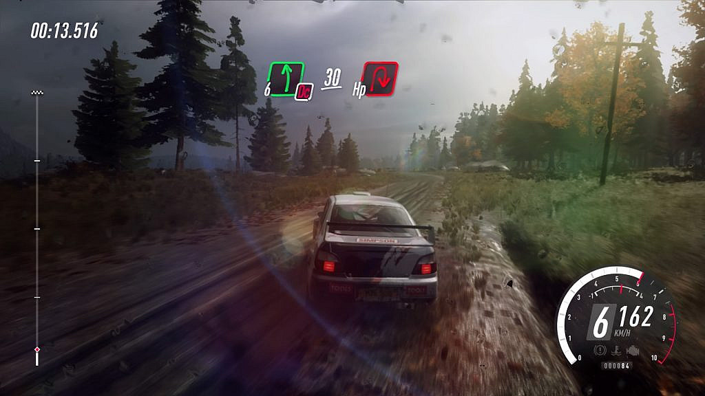 Rally car driving on a muddy road with onscreen instructions about the next turn.
