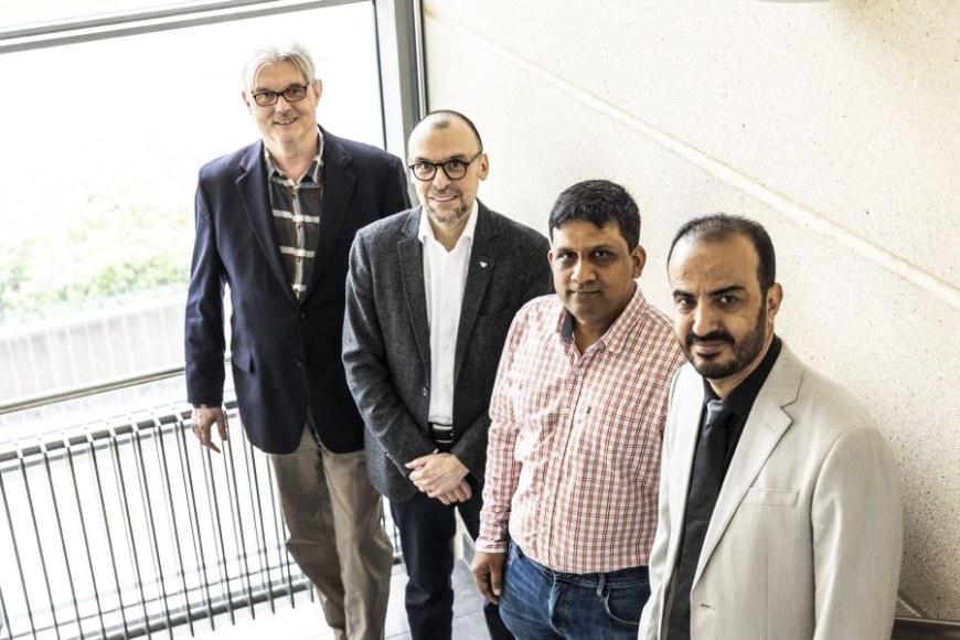 Professor Olli Yli-Harja, professor Frank Emmert-Streib, Dr. Jerome Chandraseelan and Dr. Amer Farea pose for the camera in a staircase