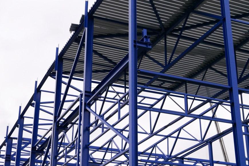 Steel structures painted in blue. Photographed towards a grey sky. Illustrative picture.