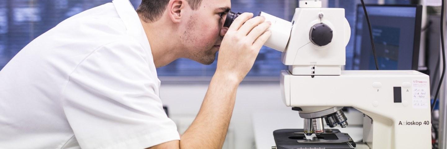 Person using optical microscope