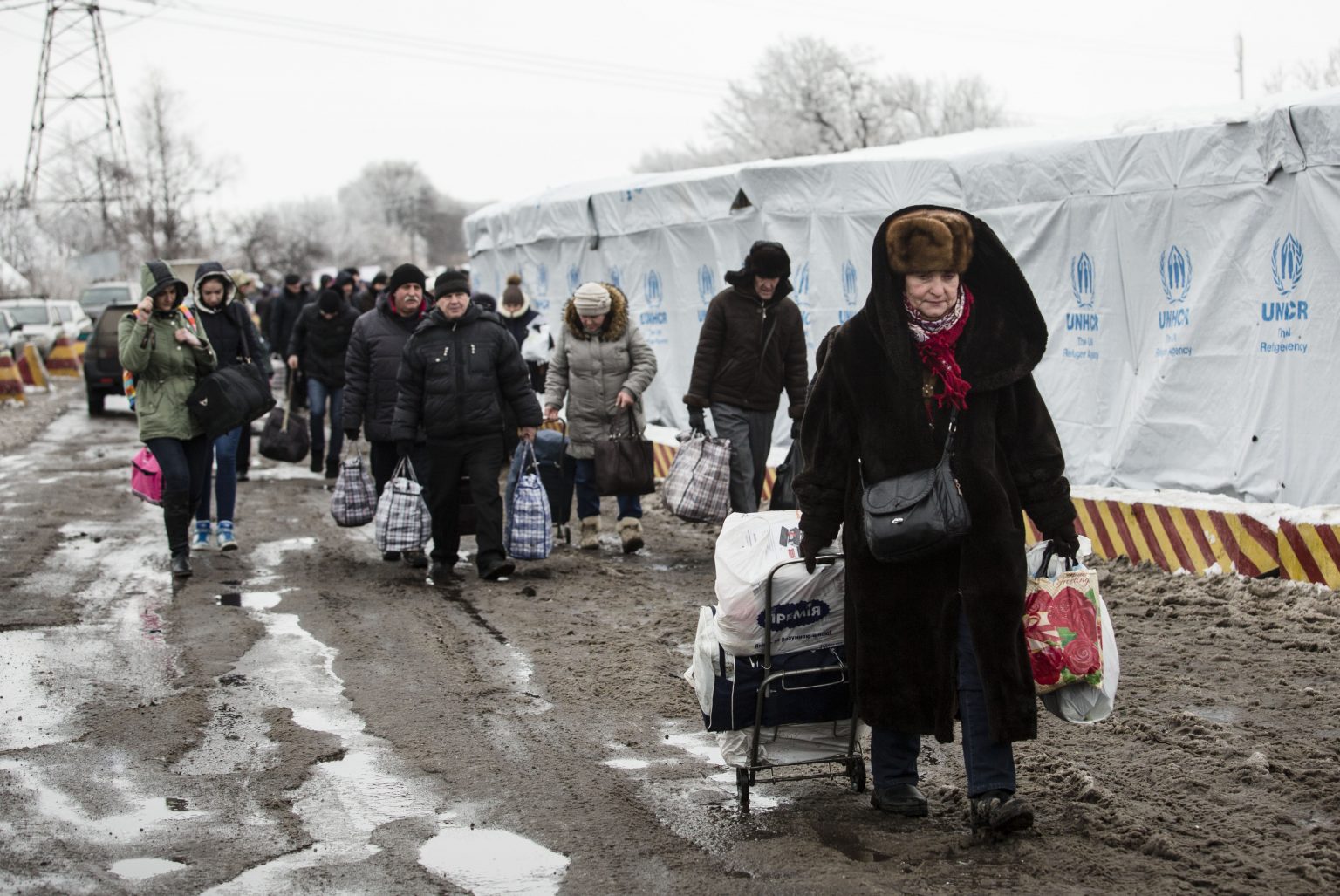 People rush to the bus stop at the border crossing point in Mayorsk, Donetsk area on Dec. 27.