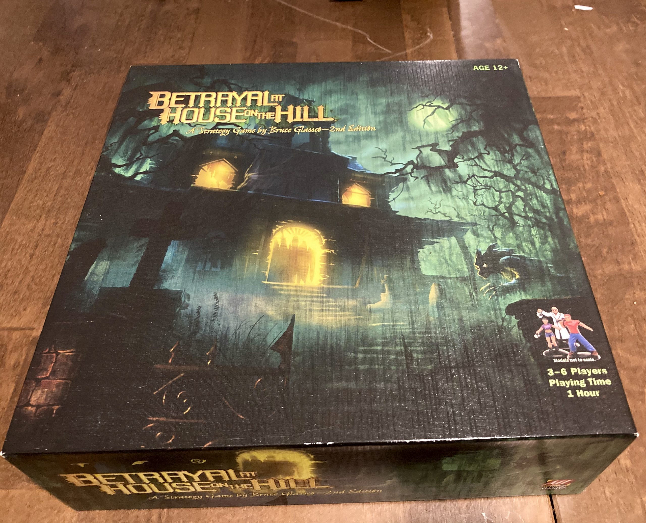 The game's box that features an illustration of a haunted house.