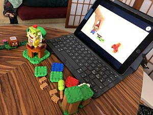 LEGOs in front of an I-Pad that displays playing instructions.