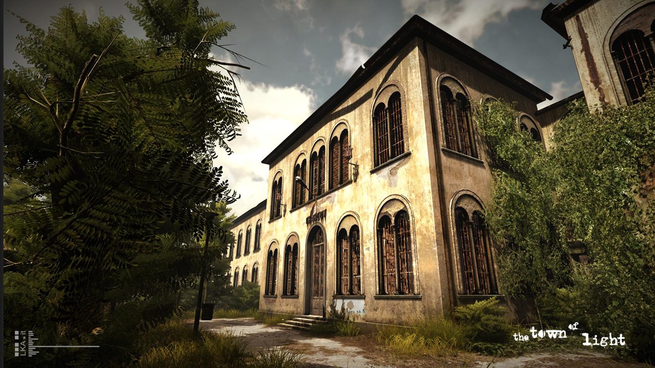 wide shot of the old and crumbling asylum bilding in evening sunshine