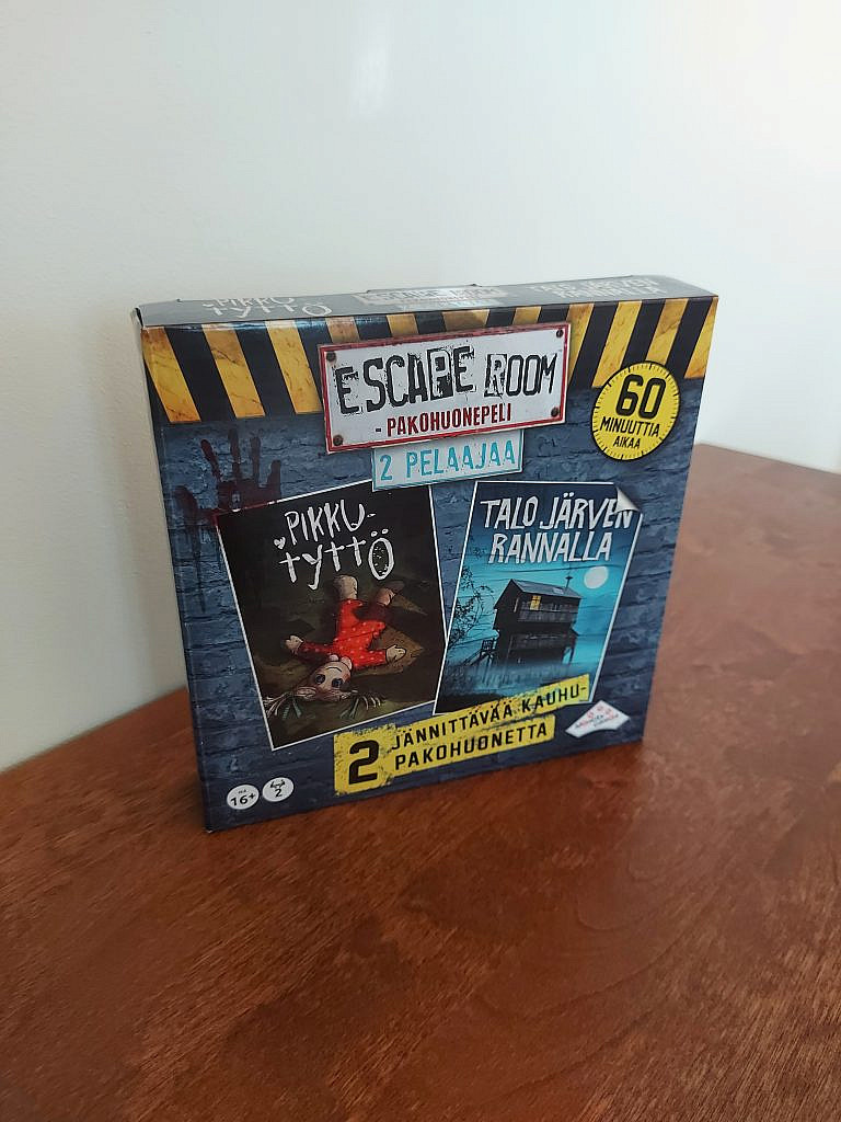 The physical box which contains horror-themed escape room board games. 