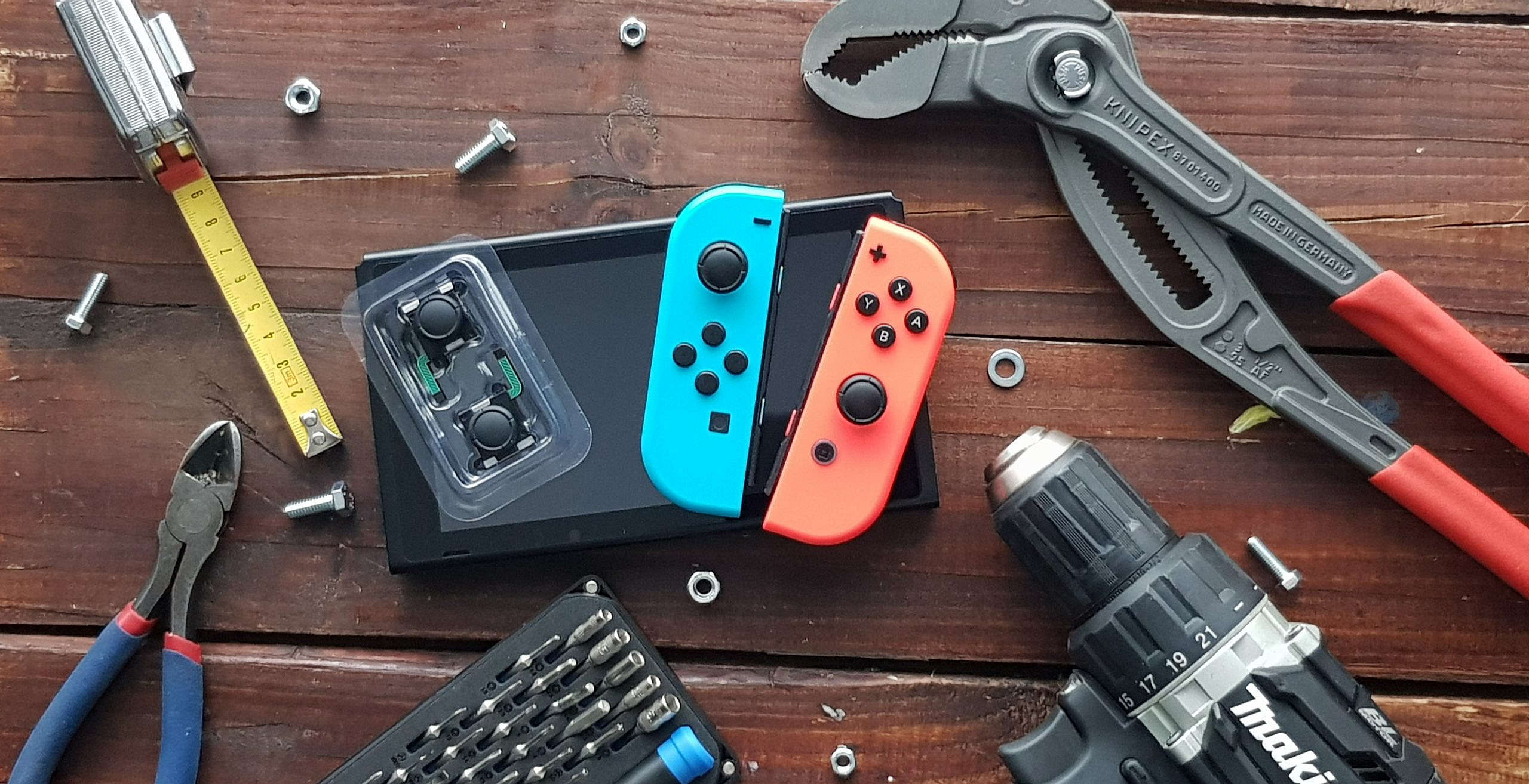 Decorative tools and Nintendo Switch with the replacement parts on top