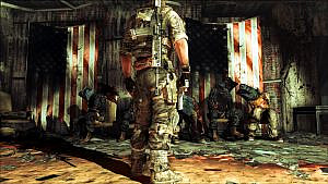 A soldier stands in front of dead, previously captured US soldiers.