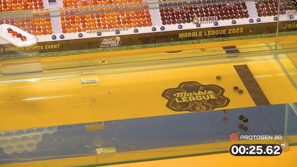 marbles advancing in the water near the finish line