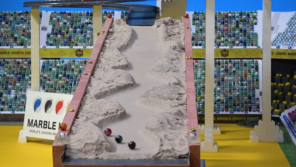 marbles rolling down a sandy trail