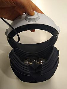 someone pushing a white button on the back of a headband