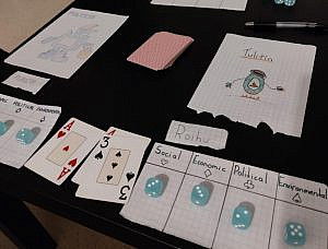 Drawn robots, cards and dice on a table