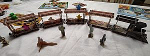3D cardboard train with wooden figures inside the carts