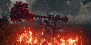 a player character in iron armor swinging a huge red hammer beneath burning soil
