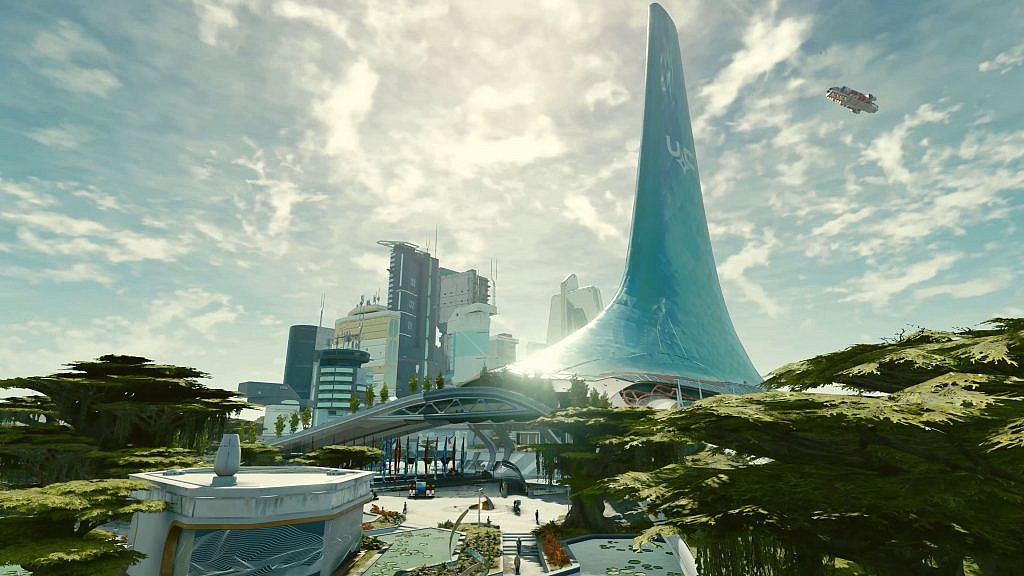 A city, with scyscrapers and a giant whale-fin shaped building gleaming in the sun. 