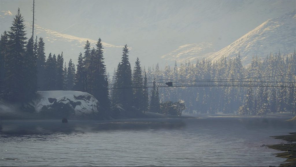 Two bears next to a forest, one is drinking from a river and another is on a bridge above the river. Mountains in the background.