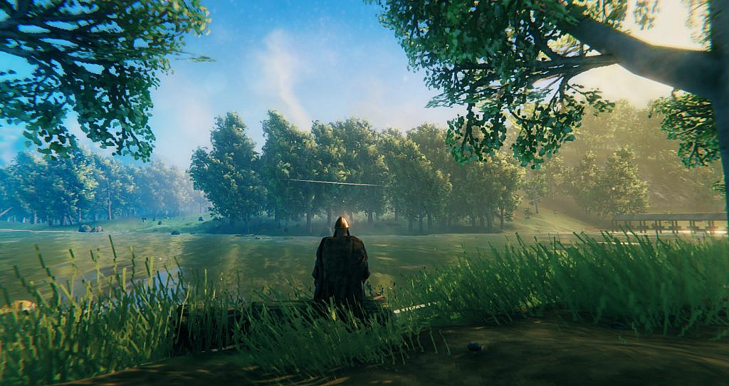 Viking sits looking across a river.