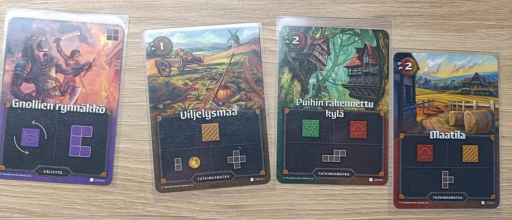 A monster card and three tile cards