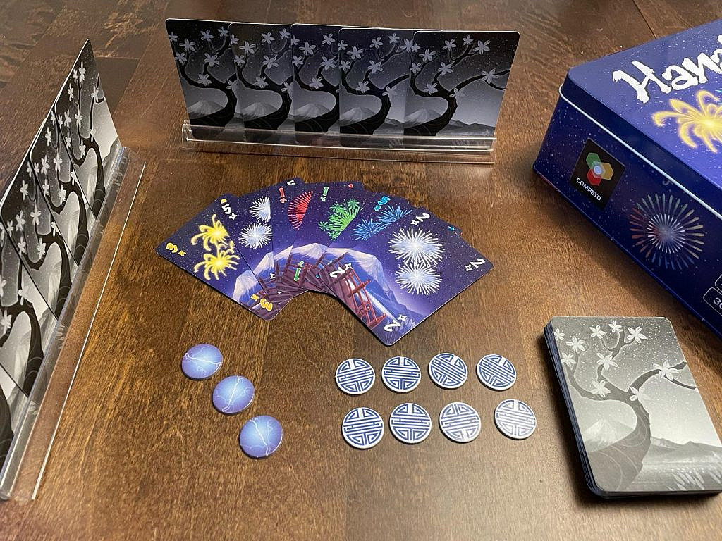 Contents of Hanabi game box layed on a table.