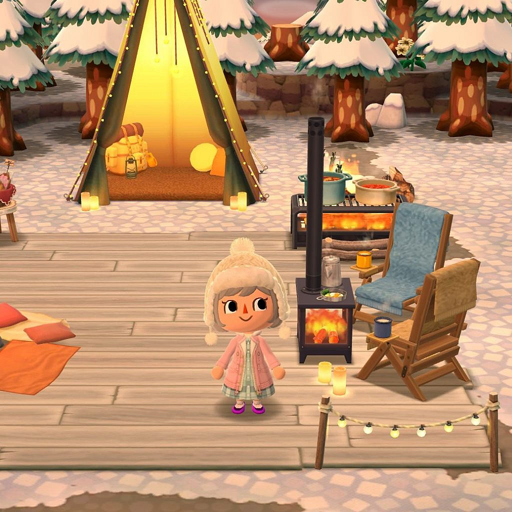 Player avatar standing in a snowy scenery. There is a tent on the background and a fireplace to sit around.