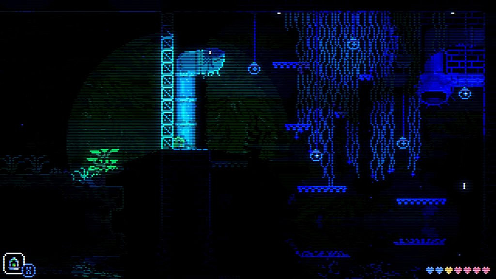 The player character of Animal Well, a small blob, shines a light through a glass wall into a shrubby area.
