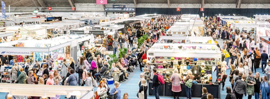 Many booths and people at the Finnish Craft and Design Fair.